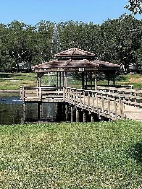 view of dock featuring a lawn and a gazebo