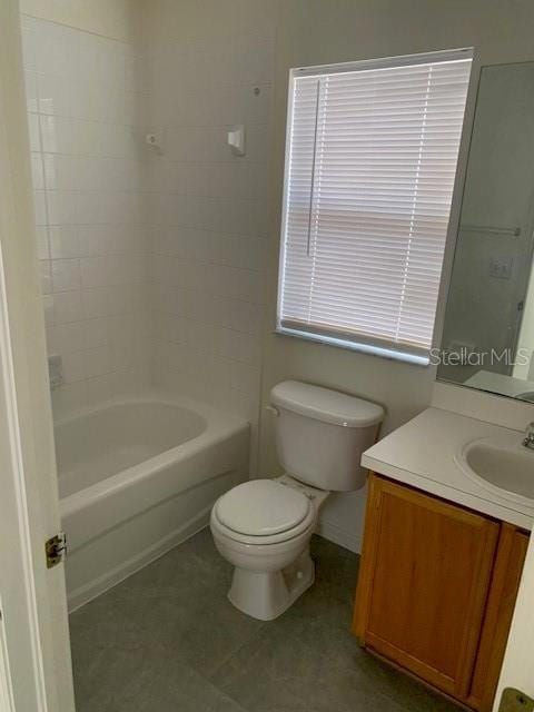 bathroom with vanity, toilet, and bathing tub / shower combination