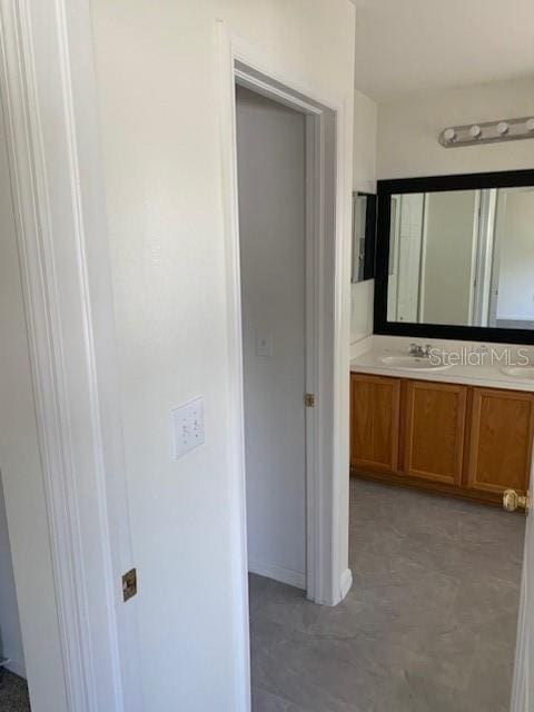 bathroom featuring double vanity and a sink