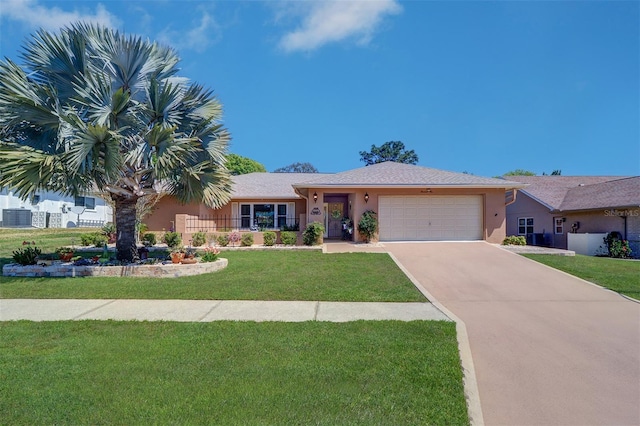 ranch-style house with central AC unit, an attached garage, concrete driveway, stucco siding, and a front lawn