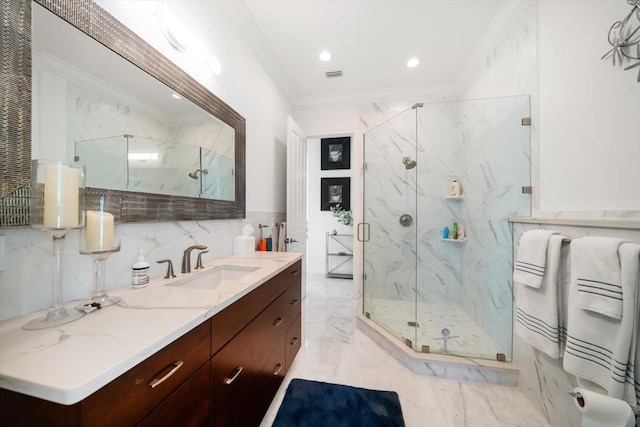 bathroom featuring marble finish floor, tile walls, a marble finish shower, ornamental molding, and vanity