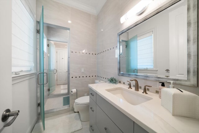 full bath featuring tile walls, visible vents, toilet, a stall shower, and vanity