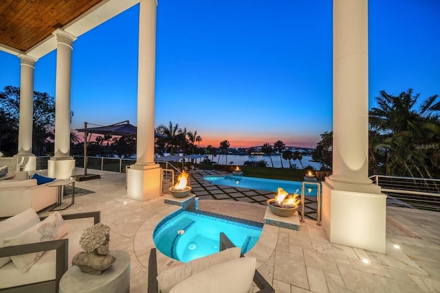 view of pool featuring a water view, a patio, a fire pit, and a gazebo