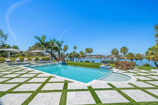 pool featuring a patio area and a water view