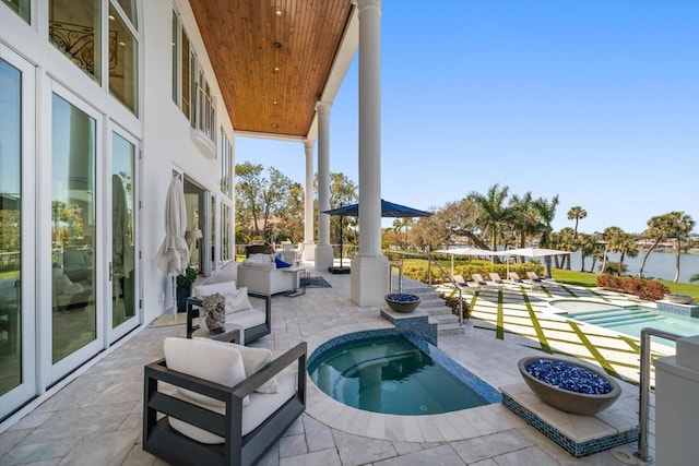 view of patio / terrace with an in ground hot tub