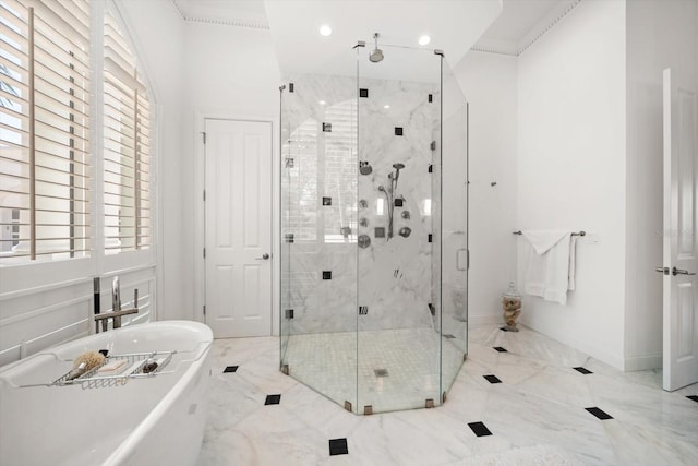 bathroom with a freestanding tub, recessed lighting, baseboards, marble finish floor, and a shower stall