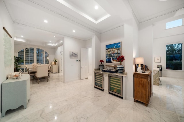 kitchen featuring marble finish floor, beverage cooler, and ornamental molding