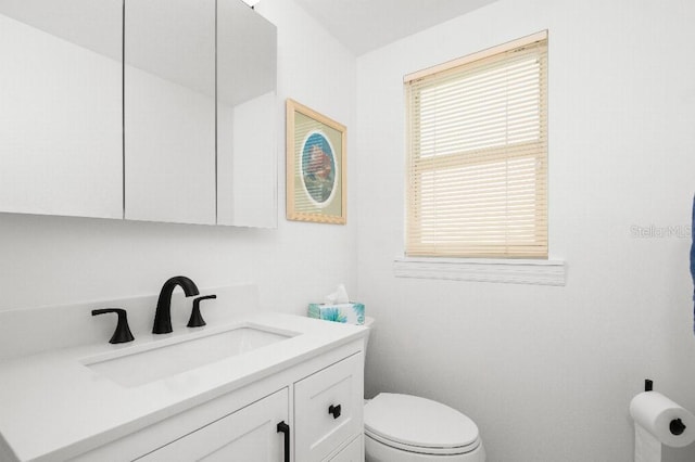 bathroom with toilet and vanity