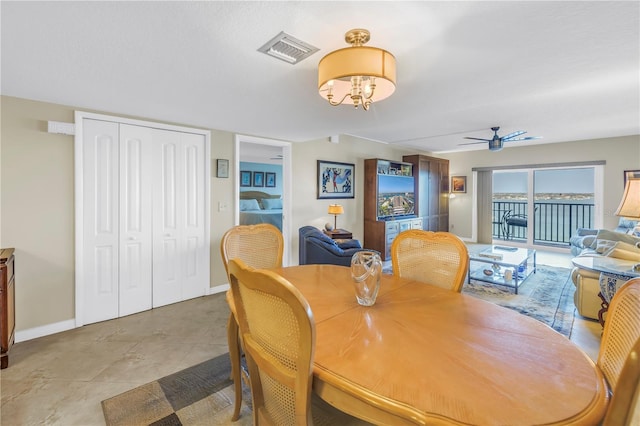 dining space featuring a ceiling fan, visible vents, and baseboards