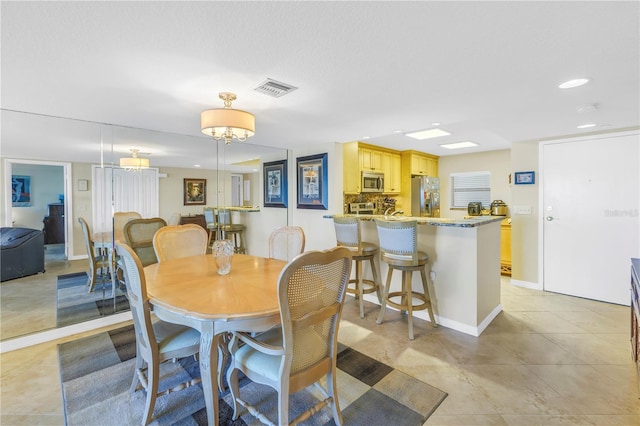 dining area with recessed lighting, visible vents, and baseboards