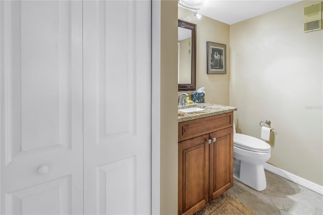 bathroom featuring visible vents, baseboards, toilet, tile patterned flooring, and vanity