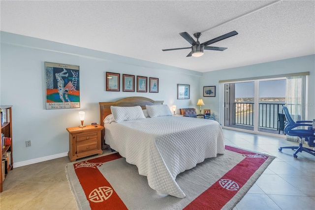 tiled bedroom featuring a textured ceiling, access to outside, a ceiling fan, and baseboards