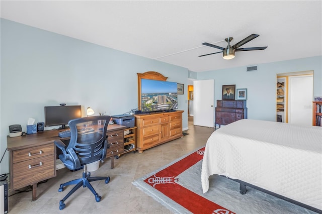 bedroom featuring tile patterned flooring, visible vents, and ceiling fan