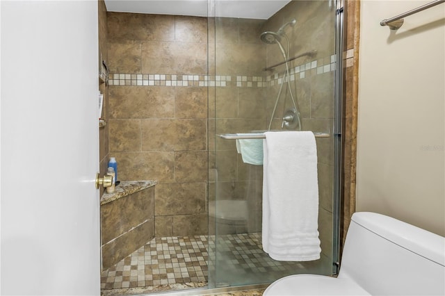 full bath featuring a stall shower and toilet