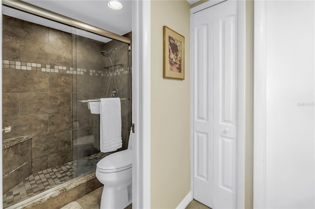 bathroom with a shower stall and toilet