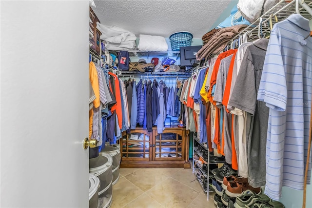 spacious closet featuring tile patterned flooring