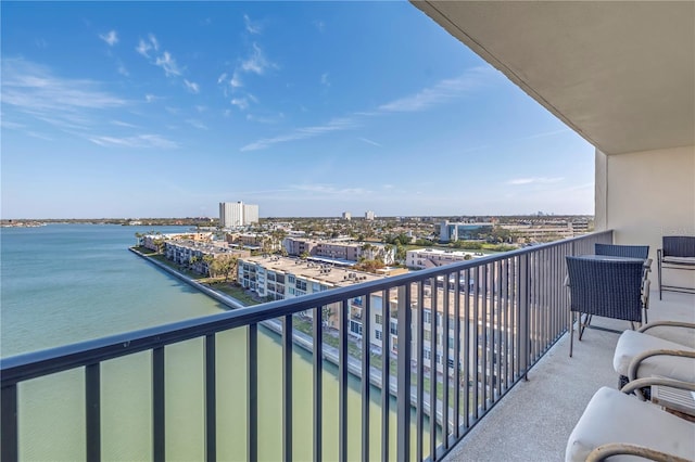 balcony featuring a water view and a city view