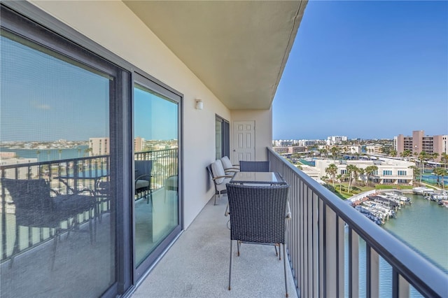 balcony featuring a water view and a city view