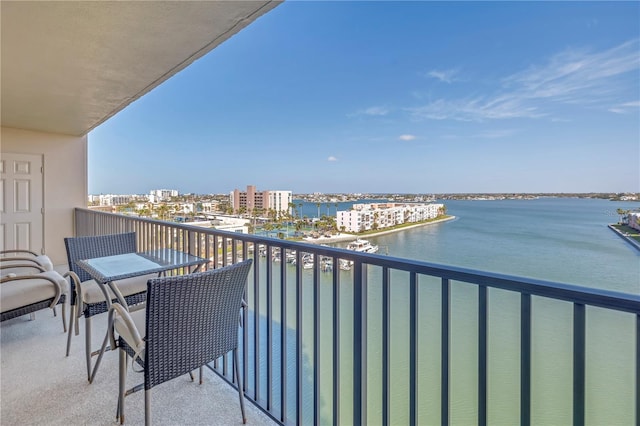 balcony featuring a water view and a city view