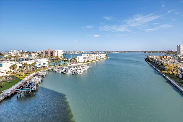 birds eye view of property with a water view and a city view