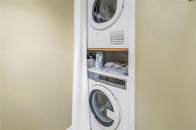 laundry room with laundry area and stacked washer and clothes dryer