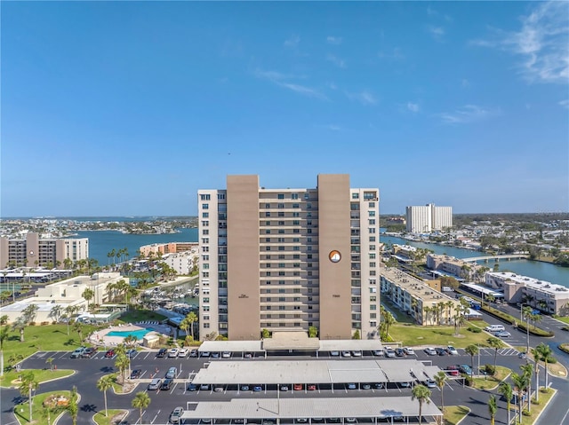 birds eye view of property featuring a water view and a view of city