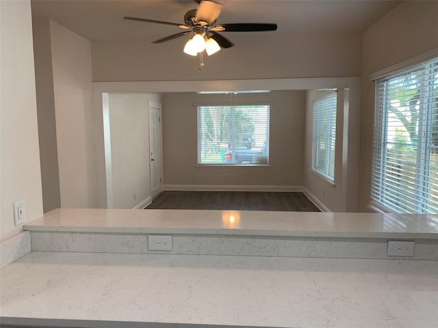 bathroom with a healthy amount of sunlight, ceiling fan, and baseboards