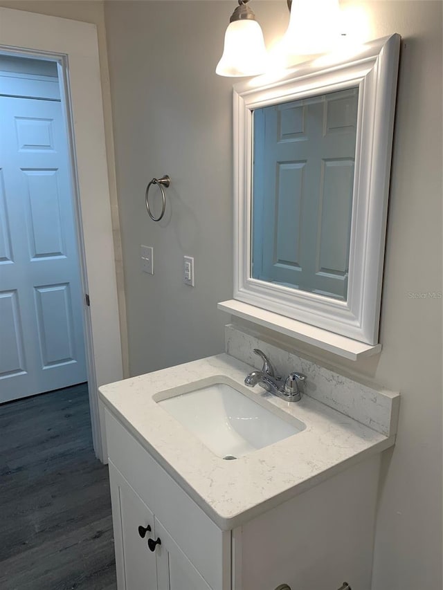 bathroom with wood finished floors and vanity