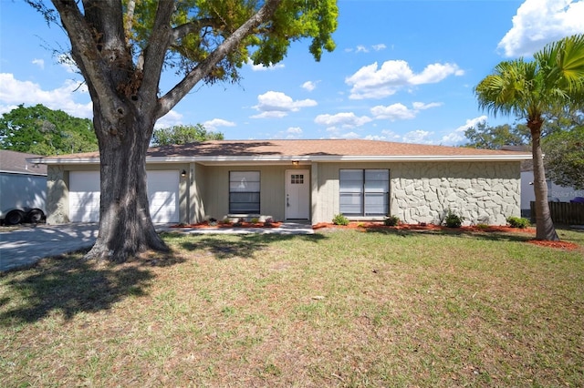 ranch-style house featuring an attached garage, stone siding, driveway, and a front lawn