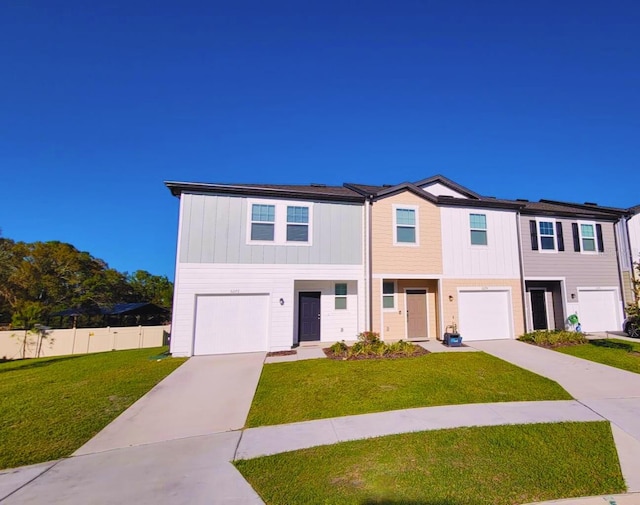 view of property featuring a garage, fence, a front lawn, and concrete driveway