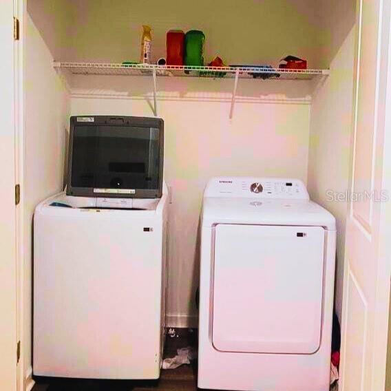 washroom featuring laundry area and washer and dryer