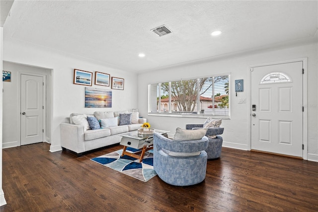 living area with recessed lighting, wood-type flooring, visible vents, a textured ceiling, and baseboards