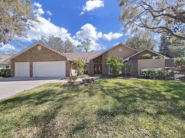 view of front of property featuring a garage, a front lawn, concrete driveway, and brick siding