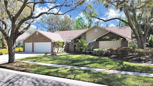 view of front of house with a garage, driveway, a front lawn, and brick siding