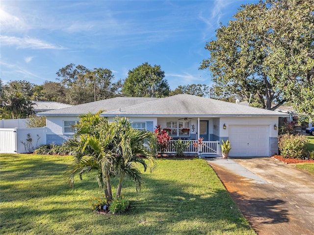 single story home with a porch, concrete driveway, fence, and a front lawn