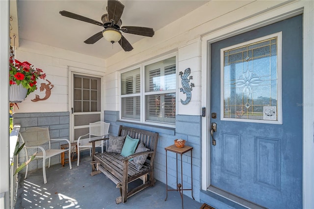 doorway to property with a porch and ceiling fan