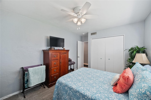 carpeted bedroom with a closet, visible vents, ceiling fan, and baseboards