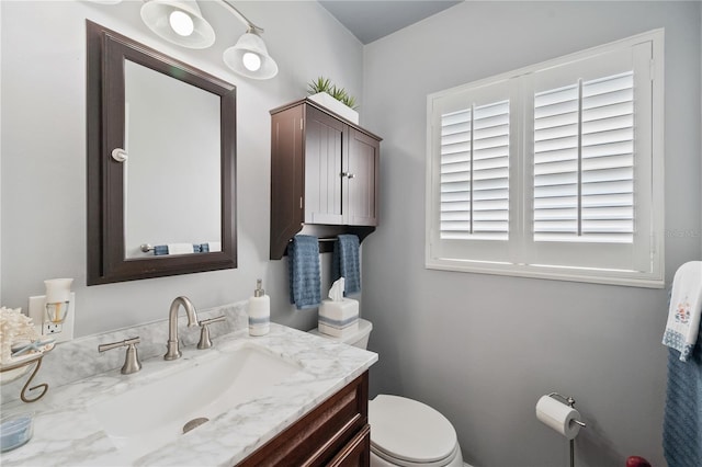 bathroom featuring toilet and vanity