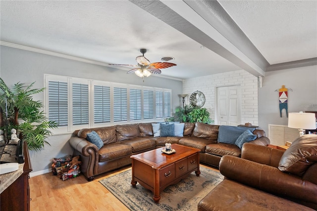 living area with visible vents, baseboards, ceiling fan, a textured ceiling, and light wood-style floors