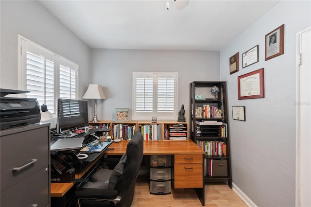 office with light wood-type flooring and baseboards