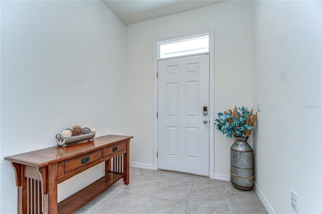 foyer entrance with light tile patterned flooring and baseboards