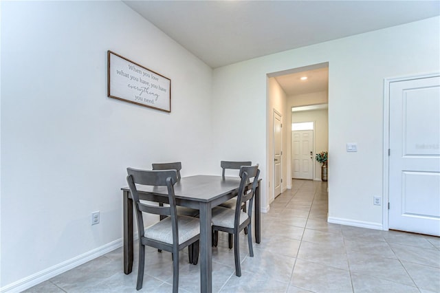 dining room with light tile patterned floors and baseboards