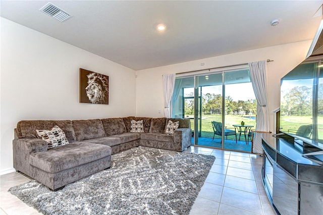 living area with light tile patterned floors and visible vents