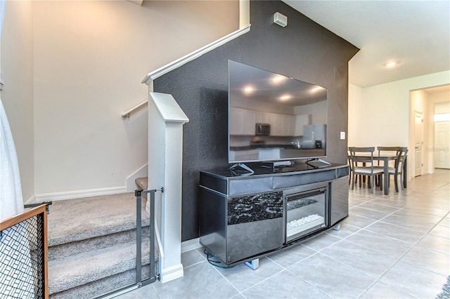 kitchen featuring dark countertops, light tile patterned floors, baseboards, and appliances with stainless steel finishes