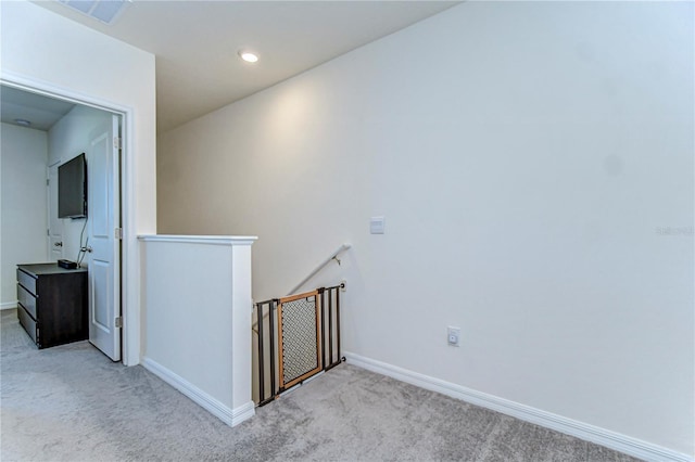 hallway with visible vents, baseboards, an upstairs landing, carpet flooring, and recessed lighting