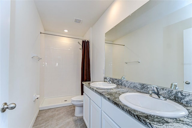 bathroom with a sink, visible vents, toilet, and a tile shower