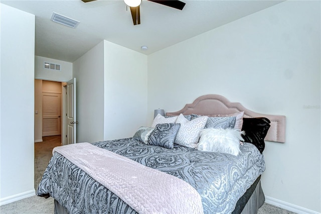 carpeted bedroom with baseboards, visible vents, and ceiling fan