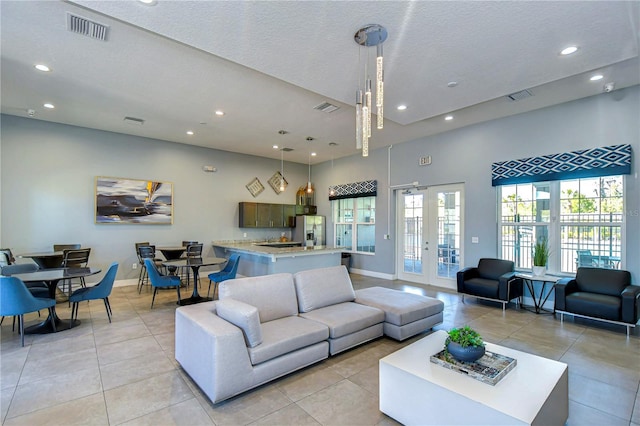 living room featuring recessed lighting, french doors, and visible vents