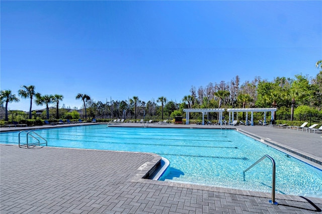 pool featuring a pergola and a patio