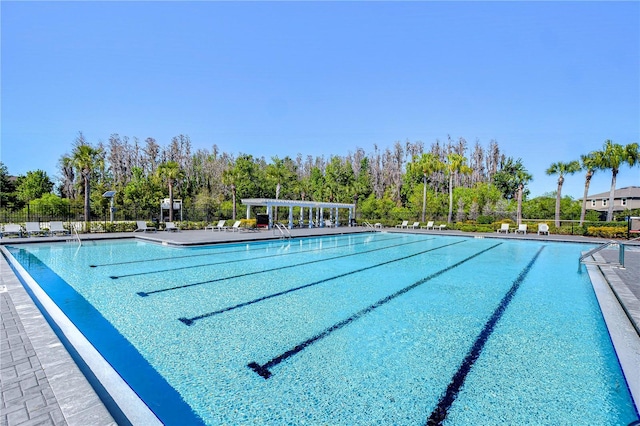 pool with a pergola and fence